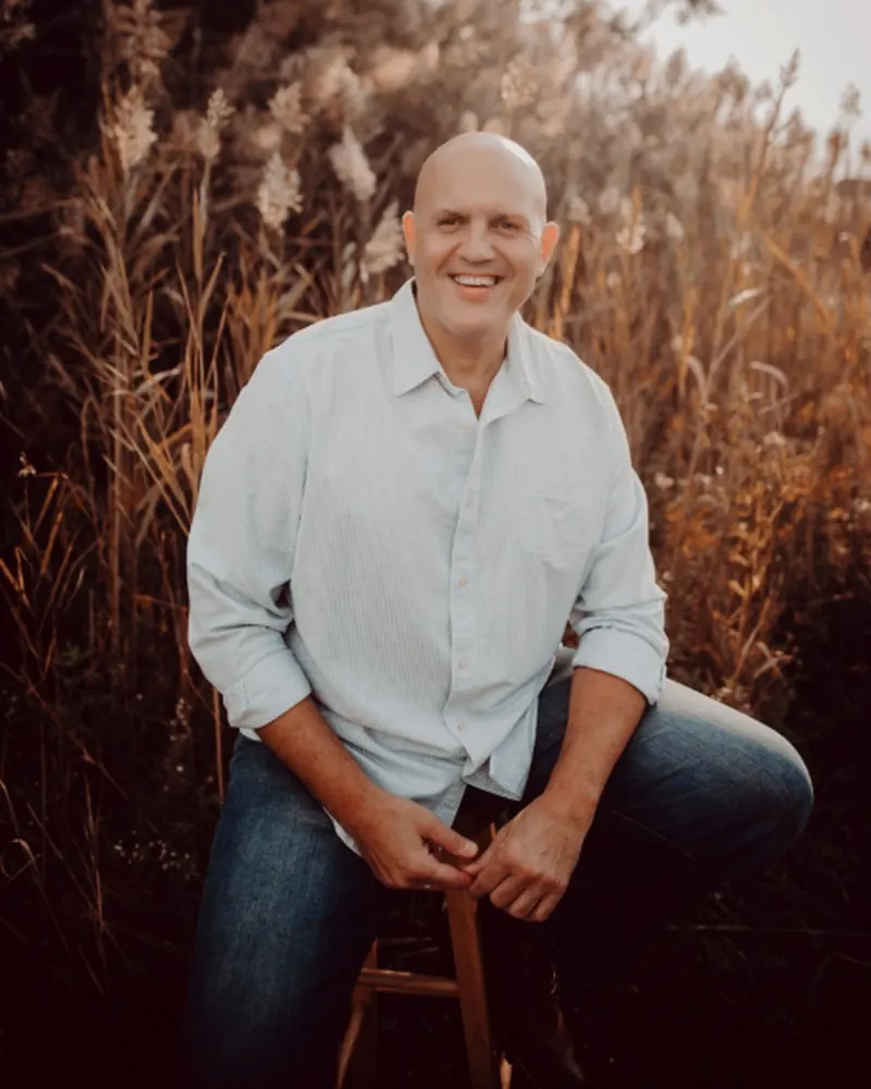 Joe Ortiz, Founder and Lead Interventionist of Transcend Interventions, seated outdoors in natural light